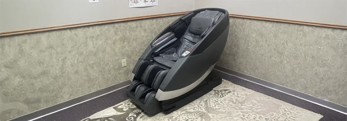 Modern massage chair positioned in a treatment room designed for patient relaxation and comfort.