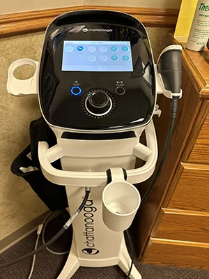 Therapeutic device with touchscreen controls used for clinical treatment sessions.